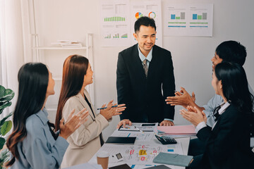 Team of financial advisory services. Asian advisor showing plan of investment to clients in the consultancy office..