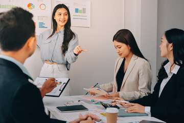Team of financial advisory services. Asian advisor showing plan of investment to clients in the consultancy office..