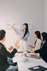 Team of financial advisory services. Asian advisor showing plan of investment to clients in the consultancy office..