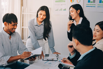 Team of financial advisory services. Asian advisor showing plan of investment to clients in the consultancy office..