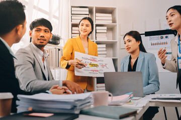 Team of financial advisory services. Asian advisor showing plan of investment to clients in the consultancy office..