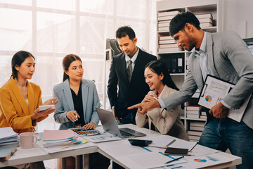 Team of financial advisory services. Asian advisor showing plan of investment to clients in the consultancy office..