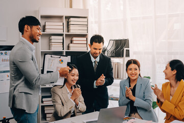 Group of Young Asian business team creative businesspeople coworker in office Happy to be successful partnership teamwork celebrating achievement and success concept.