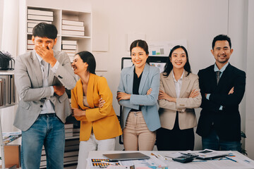 Group of Young Asian business team creative businesspeople coworker in office Happy to be successful partnership teamwork celebrating achievement and success concept.