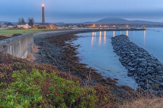 Coastal scene at dawn, with lighthouse
