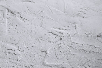 White acrylic textured plaster. Drops, lines, arrows, cracks in close-up. Drawing with a spatula