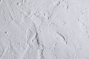 White acrylic textured plaster. Drops, lines, arrows, cracks in close-up. Drawing with a spatula