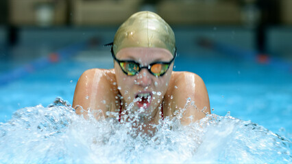 Athlete glides through water, embodying strength and focus. Close-up shot accentuates determination...