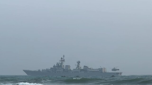 INS Vikrant during navy drill at sea with small boats in India