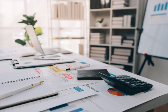 Team of financial advisory services. Asian advisor showing plan of investment to clients in the consultancy office..