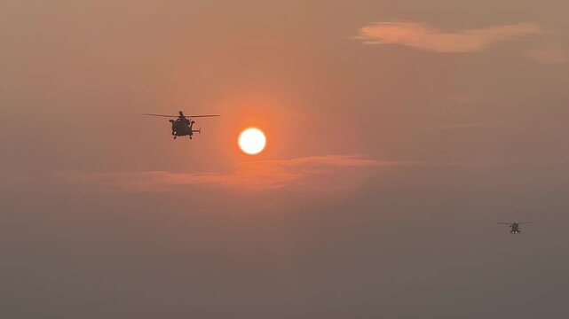 MH-60R SEAHAWK Helicopter Indian navy helicopters silhouette view with sun in the orange sky