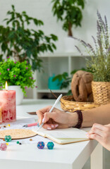 Woman astrologer draws a natal chart. Selective focus