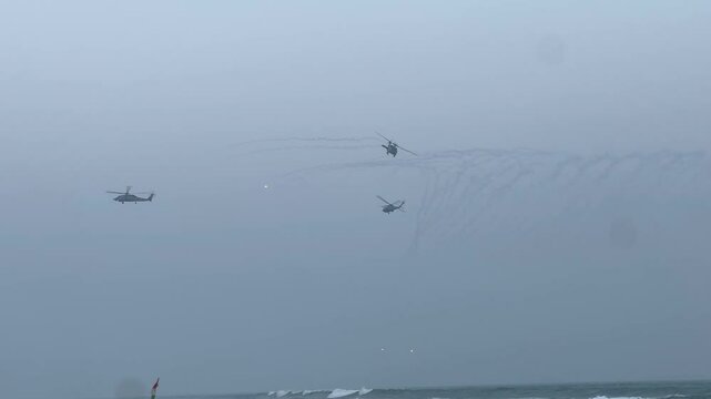 MH-60R SEAHAWK Indian Navy Helicopters shooting flares in the sky.