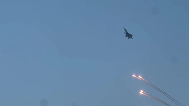 Three Sukhoi Su-30MKI Indian Navy planes shooting flares in the sky.