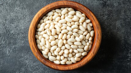 Fototapeta premium Wooden bowl filled with many white beans.