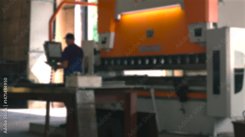 Poster operator skillfully bends metal components in a manufacturing setting