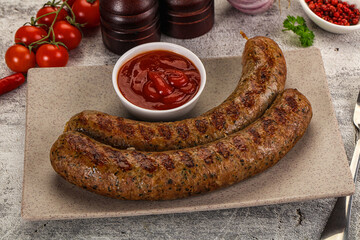 Grilled beef sausages with sauce