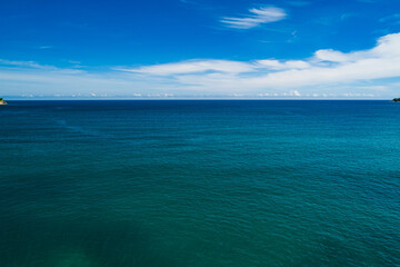 Fototapeta premium Aerial view Top down seashore, Waves crashing on rocks cliff, Beautiful sea surface in sunny day summer background, Amazing seascape top view seacoast at Phuket Thailand