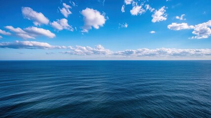 Obraz premium A panoramic view of a vast, deep blue ocean stretching to the horizon under a bright, sunny sky with fluffy white cumulus clouds. : Generative AI