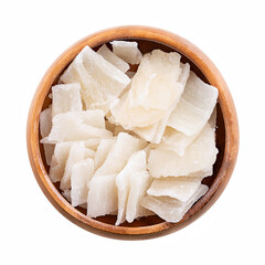 Aloe vera slices, dried and sugared, in wooden bowl. Unique dessert or snack with chewy texture, and with sweet and tangy flavor. Translucent and opaque chips of the leaves of the succulent Aloe vera.
