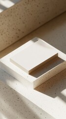 Minimalist White Square on Textured Surface with Natural Lighting