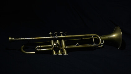 an old Jazz trumpet from the 1920s on a black background