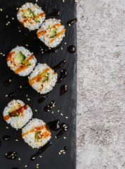 Japanese sushi rolls on a blackboard