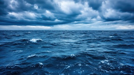 Fototapeta premium A dramatic seascape featuring a vast, deep blue ocean under a brooding, dark sky filled with heavy storm clouds. : Generative AI