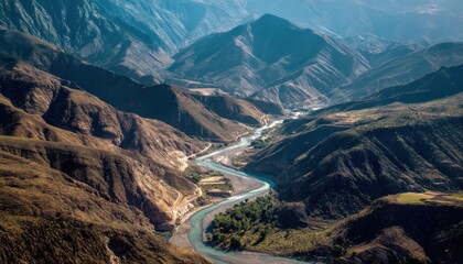 A flowing river carves its way through the mountains