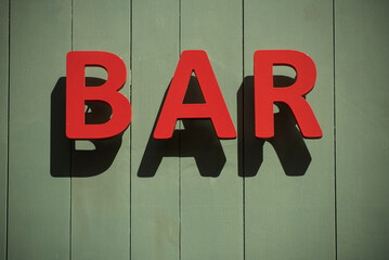 Closeup of bar signage on the wall in the street