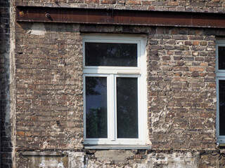 Modern White Window Installation in Historic Brick Wall Shows Architectural Renovation and Preservation Efforts