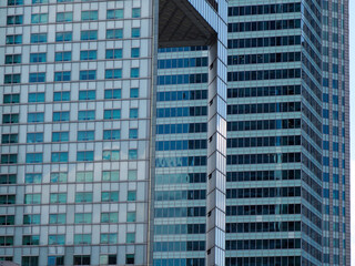 Modern Glass Skyscrapers in Business District with Geometric Patterns and Blue Sky Reflections