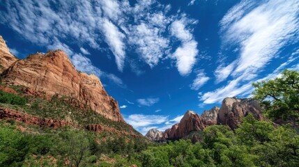Obraz premium Majestic Zion Canyon cliffs rise under a vibrant blue sky, dotted with fluffy white clouds; lush green vegetation at the base adds a vibrant contrast. : Generative AI