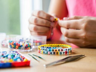 Person creating personalized friendship bracelet with message


