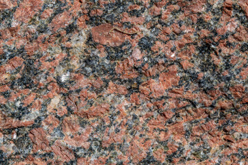 Close up of red granite rock which some of the columns are made of at Caesarea National Park in Caesarea, Israel.
