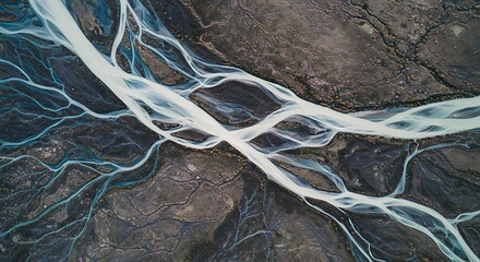 Aerial braided river channels over volcanic soil with glacial water flow. Stunning earth patterns for abstract and natural backgrounds.