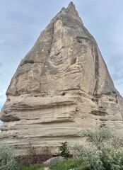 Tall, towering rock formations rise dramatically in Goreme, Cappadocia, capturing the unique...