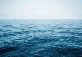 Fototapeta premium A serene, expansive view of a calm ocean under a hazy sky, showcasing the tranquil, deep blue water with subtle waves. : Generative AI
