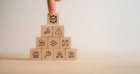 Business Crisis Management Concept. Wooden blocks with crisis management icons, strategic response, planning in challenging situations. Corporate preparedness, decision-making and risk mitigation.