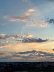 Vibrant clouds stretch across the horizon as the sun sets over Cappadocia, illuminating the unique rock formations and valleys of Goreme. A stunning end to the day