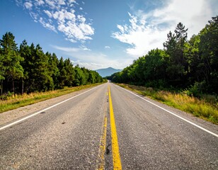 Fototapeta premium Scenic Open Road Stretch Surrounded by Lush Trees and Mountains