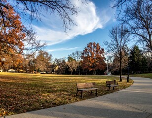 Fototapeta premium Tranquil Autumn Park Scene with Clear Blue Sky and Colorful Trees