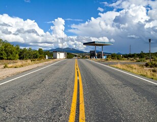 Empty Highway Leading to a Solitary Gas Station Under Blue Sky