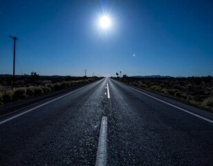 Fototapeta premium Serene Desert Road Under Bright Moonlight at Nighttime