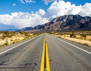 Fototapeta premium Scenic Highway View with Mountains and Blue Sky in Background