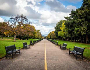 Fototapeta premium Serene Park Path with Benches and Vibrant Autumn Foliage