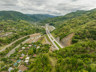 Aerial view of a quiet highway passing through a tunnels in a picturesque hilly region Rikoti Pass