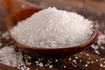 Granulated sugar in a spoon, detail macro photography of the granules