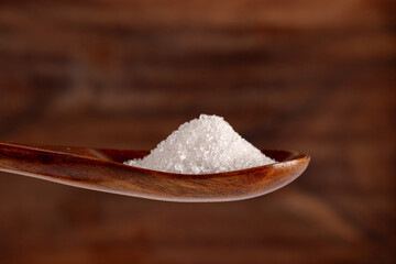 Granulated sugar in a spoon, detail macro photography of the granules