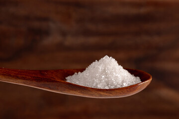 Granulated sugar in a spoon, detail macro photography of the granules